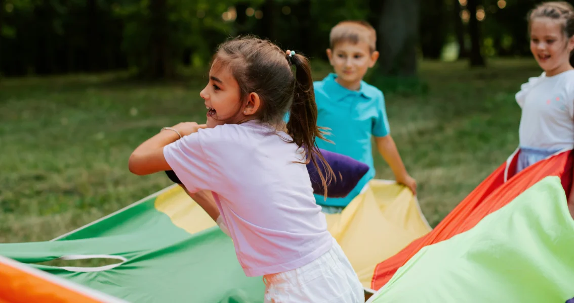 Adoptive children playing at a park during a community event.
